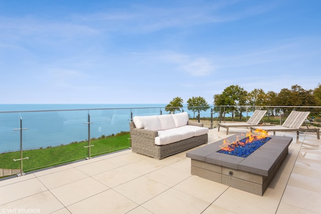 view of patio featuring a fire pit and a water view