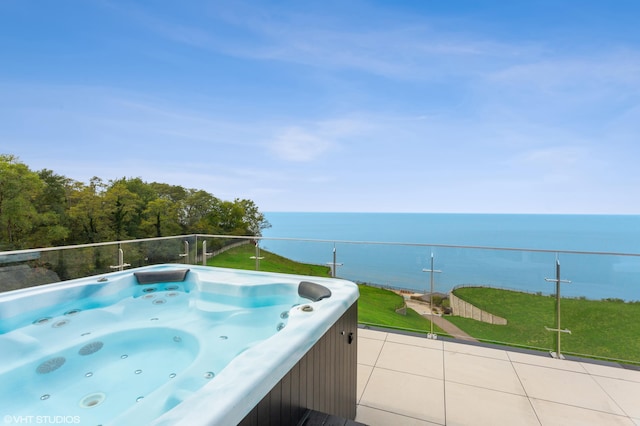 view of swimming pool featuring a water view and a hot tub