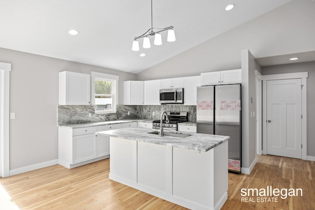 kitchen featuring sink, white cabinetry, hanging light fixtures, and appliances with stainless steel finishes