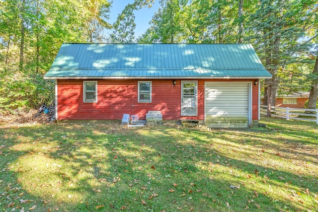 back of property featuring a lawn