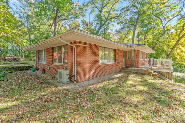 view of property exterior featuring ac unit and a deck