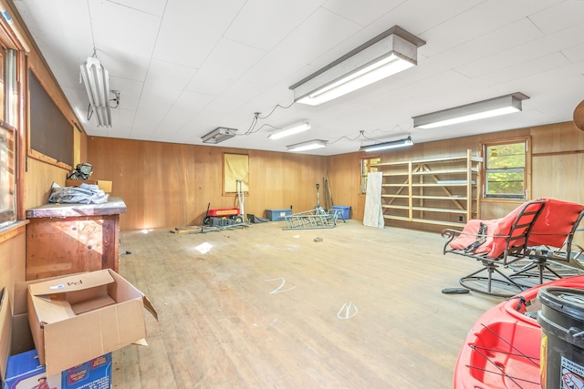 misc room with wooden walls and wood-type flooring