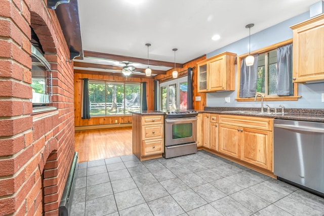 kitchen featuring ceiling fan, hanging light fixtures, sink, kitchen peninsula, and appliances with stainless steel finishes