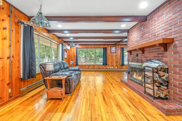 living room featuring light wood-type flooring, a brick fireplace, beam ceiling, wood walls, and baseboard heating