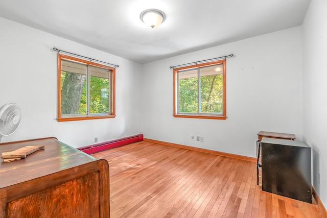 office featuring a baseboard radiator and light wood-type flooring