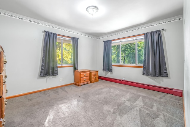 carpeted empty room featuring a baseboard radiator