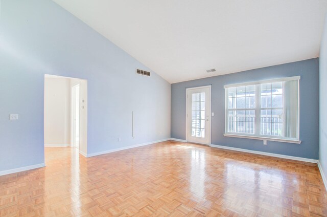 unfurnished room featuring high vaulted ceiling and light parquet floors