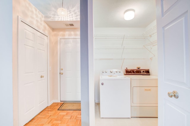 washroom with independent washer and dryer and light parquet floors