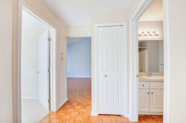 hall with light parquet flooring and sink