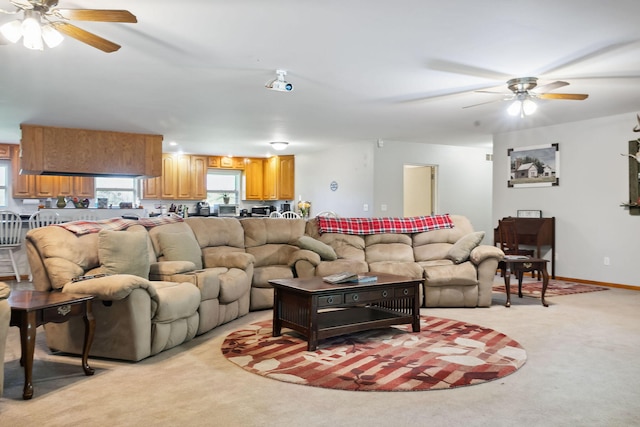 carpeted living room with ceiling fan