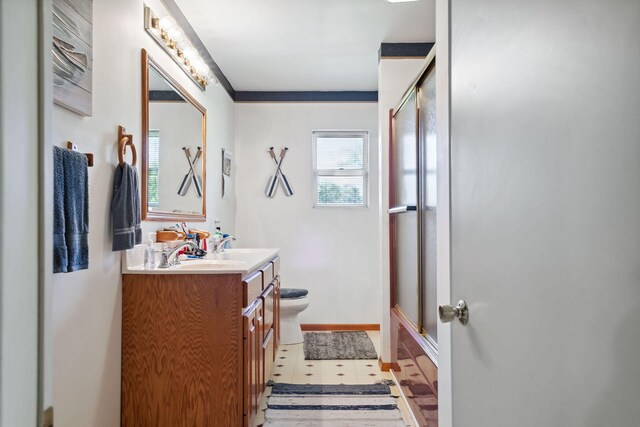 bathroom with an enclosed shower, tile patterned floors, vanity, and toilet