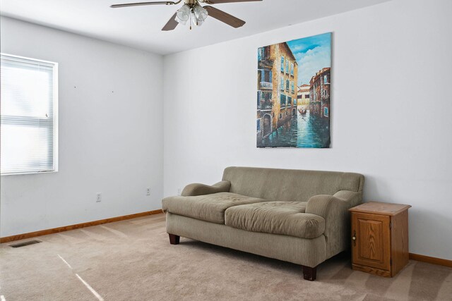 sitting room featuring light carpet and ceiling fan