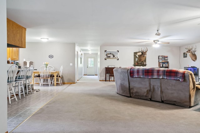 living room featuring ceiling fan and light colored carpet