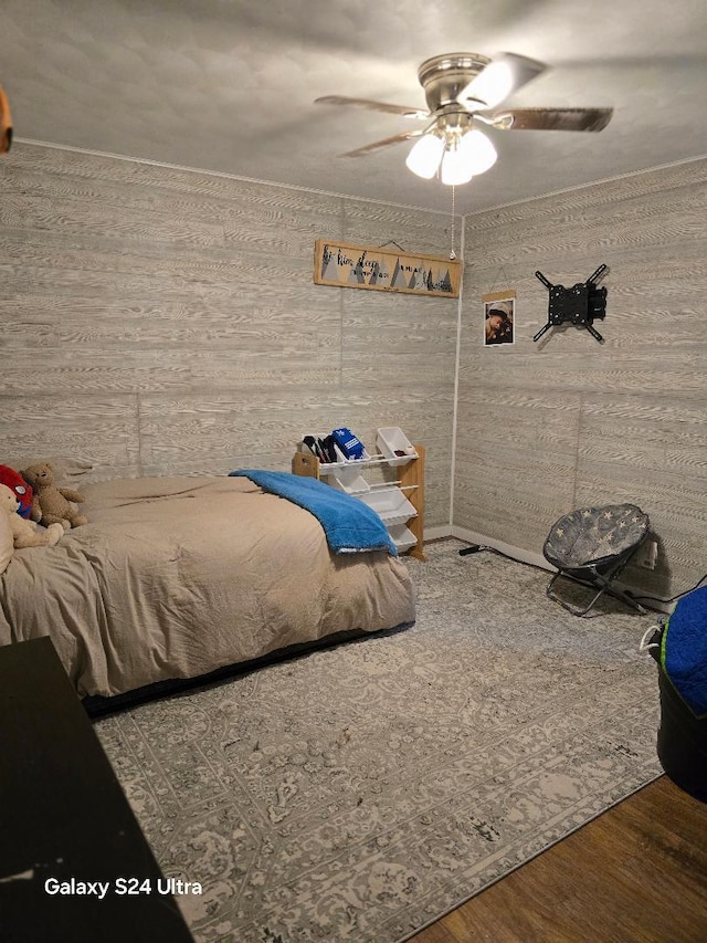 bedroom with ceiling fan and wood-type flooring