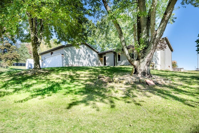 view of front of house featuring a garage and a front lawn