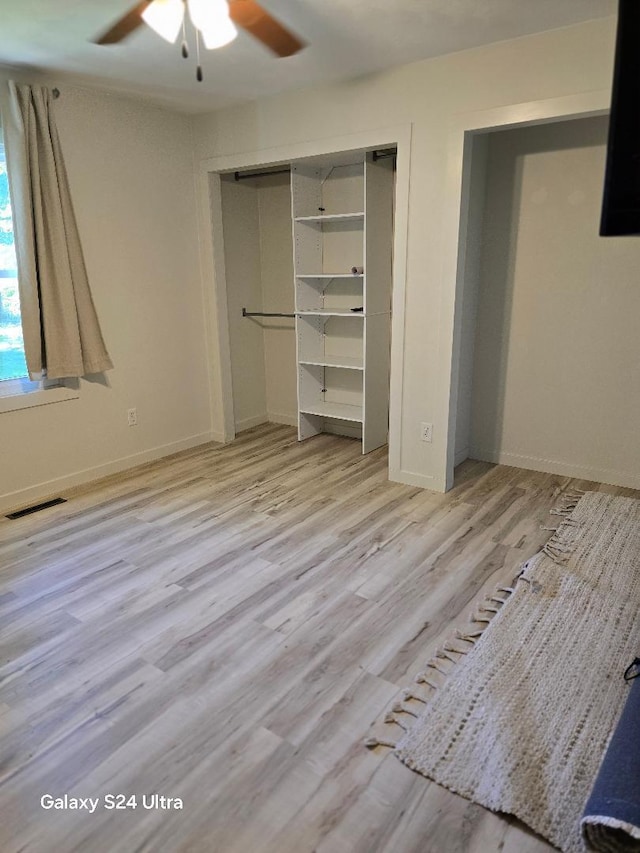 unfurnished bedroom with a closet, light wood-type flooring, and ceiling fan