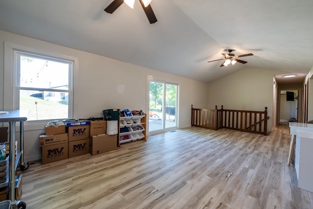 living room featuring lofted ceiling, light hardwood / wood-style floors, and ceiling fan