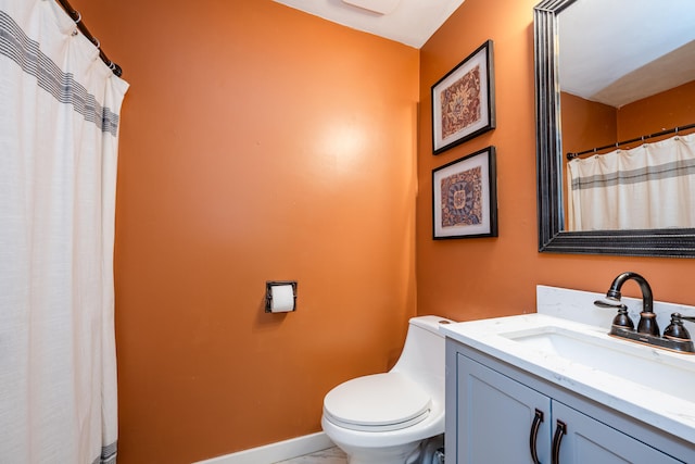 bathroom featuring vanity and toilet