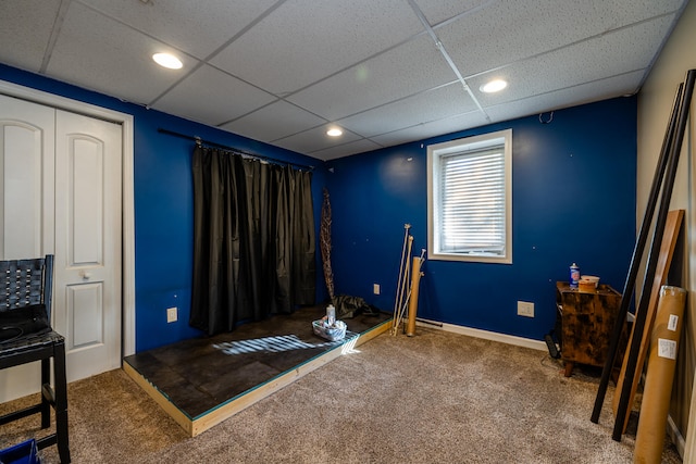 miscellaneous room with carpet floors and a drop ceiling