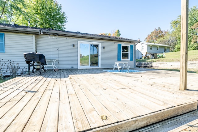 wooden deck with a grill