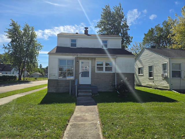 view of front of home with a front yard and cooling unit