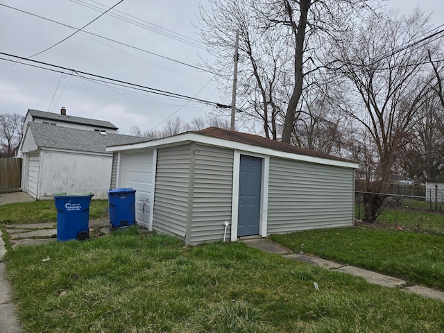 view of outbuilding featuring a garage and a yard