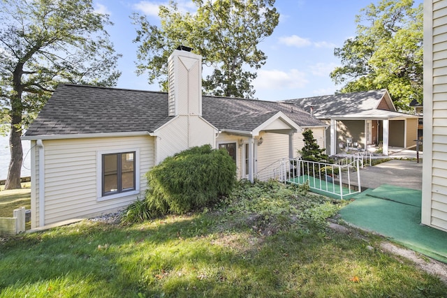 exterior space featuring a patio area and a front lawn