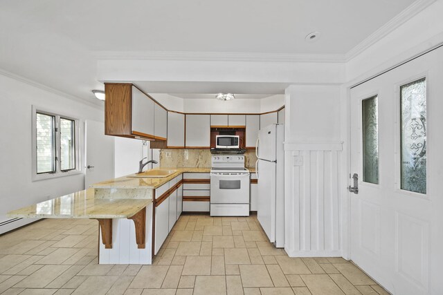 kitchen with white appliances, sink, kitchen peninsula, backsplash, and white cabinetry