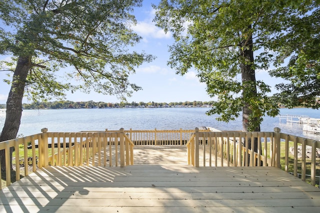 wooden terrace featuring a water view