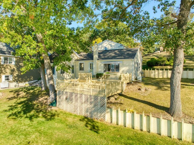 back of house featuring a deck and a yard