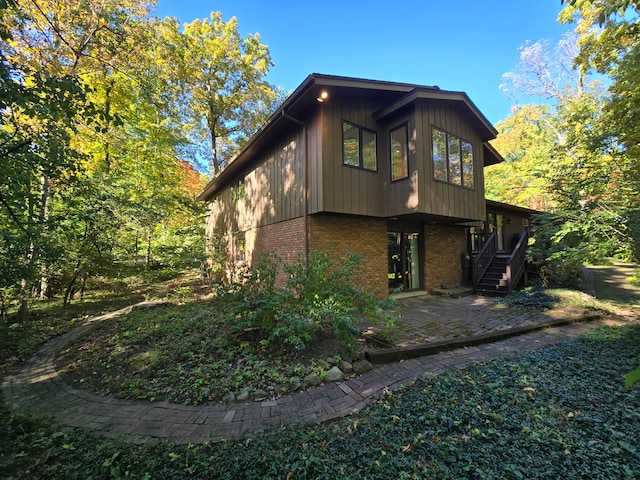 view of side of home with a patio