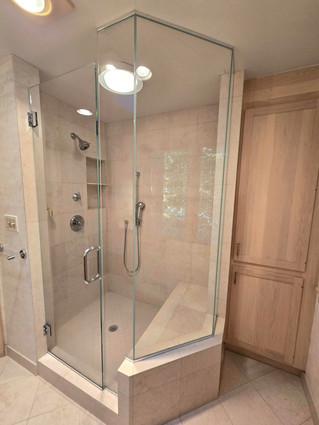 bathroom featuring tile patterned flooring and a shower with door