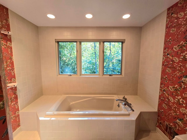 bathroom with a relaxing tiled tub