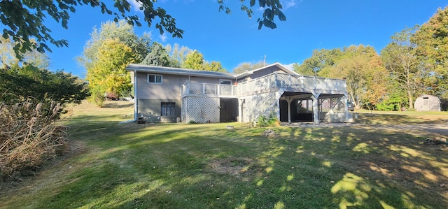 back of house featuring a yard and a storage unit