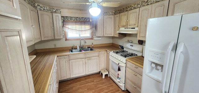 kitchen with ceiling fan, hardwood / wood-style flooring, light brown cabinetry, sink, and white appliances