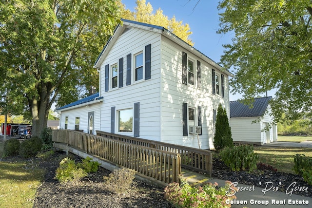 view of property exterior with cooling unit and a deck