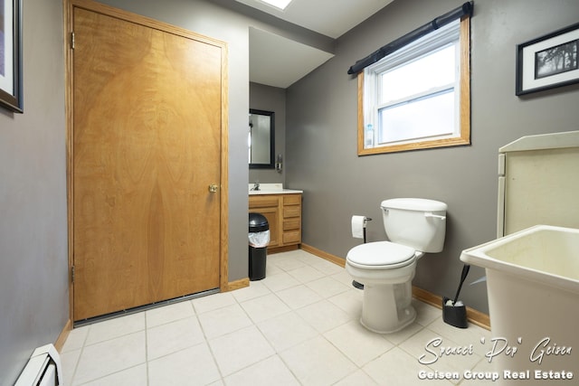 bathroom with tile patterned floors, vanity, toilet, and baseboard heating