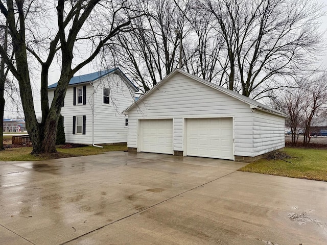 view of home's exterior with a garage and an outdoor structure