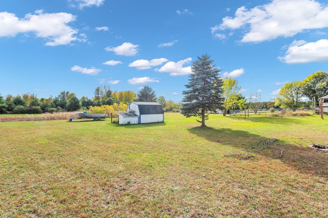 view of yard featuring a storage shed and a rural view