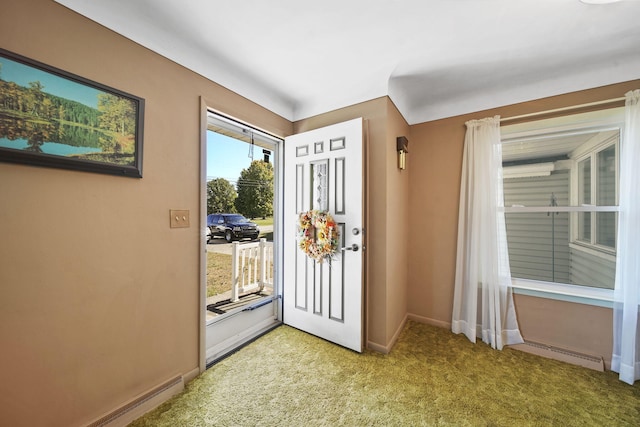 entryway with light carpet and a baseboard heating unit