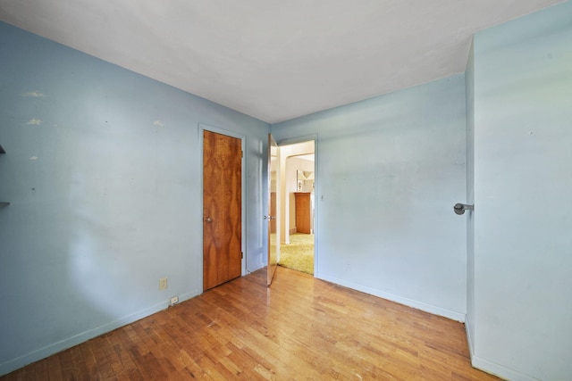 unfurnished room with light hardwood / wood-style floors