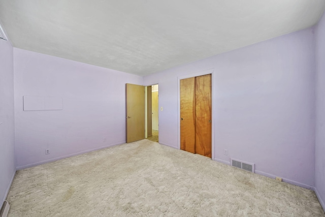 unfurnished bedroom with a closet and carpet