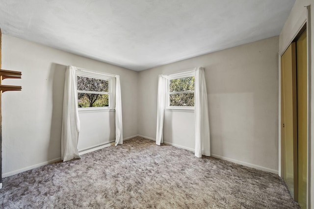 unfurnished bedroom featuring carpet floors and a closet