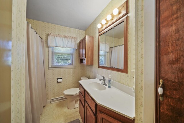 bathroom featuring baseboard heating, vanity, and toilet