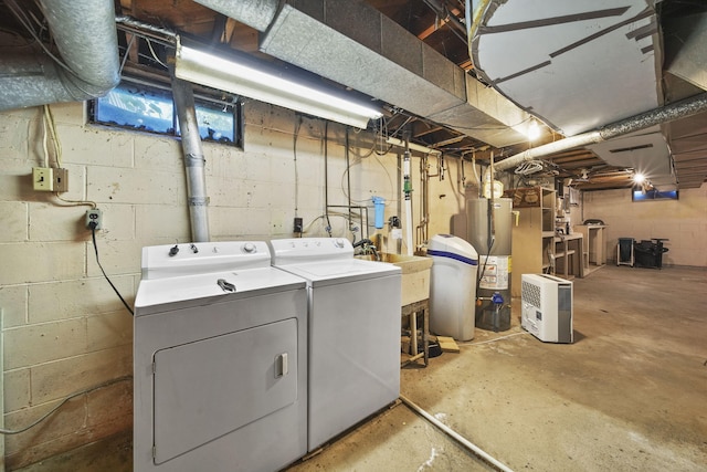 laundry area featuring gas water heater and washing machine and dryer