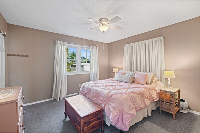 carpeted bedroom featuring ceiling fan and a textured ceiling