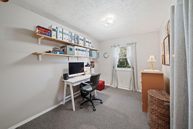 office area with a textured ceiling and carpet flooring