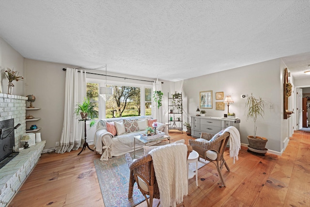 living room featuring a textured ceiling and light hardwood / wood-style floors