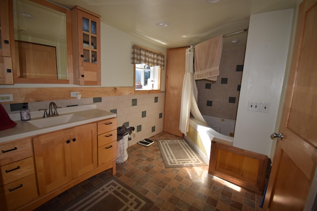 bathroom with shower / tub combo with curtain, vanity, and tile walls