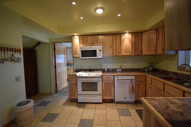 kitchen featuring light tile patterned floors, sink, and white appliances